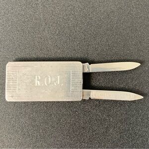 Imperial stainless steel money clip with knife and file.
